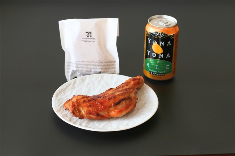 皿に盛られたセブンイレブンの直火焼ローストチキンレッグとよなよなエールの画像。